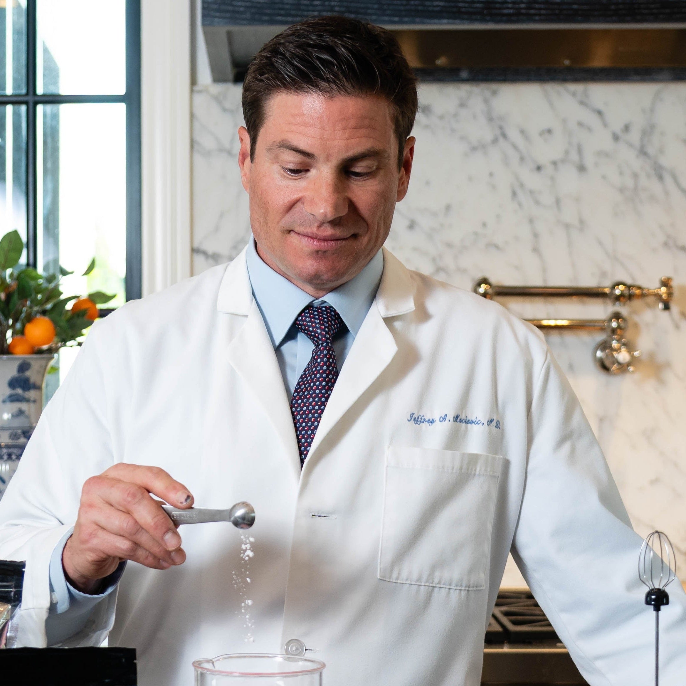 Doctor in a kitchen setting with ingredients and kitchenware